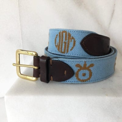A blue belt with brown and gold monogram.