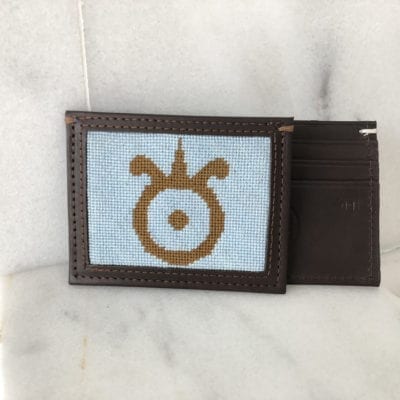 A brown wallet with an image of the symbol for taurus.
