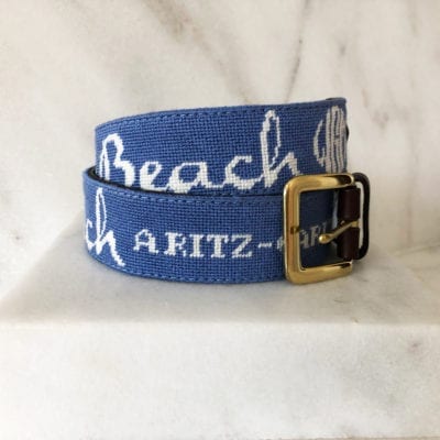 A blue belt with the words " beach " and " beach a ritz ".