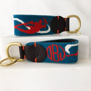A key chain with an embroidered lobster and monogram.