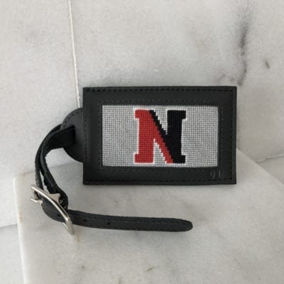 A luggage tag with the letter n on it.