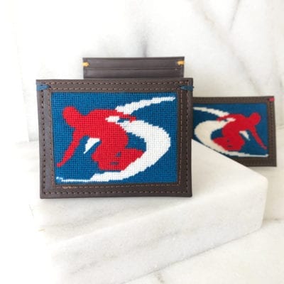 A pair of red and blue clutches sitting on top of a table.