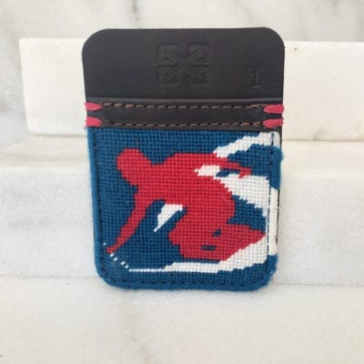 A red, white and blue wallet with a skier on it.