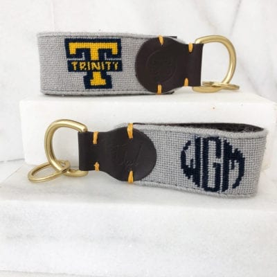 A key chain with the letters t, and trinity.