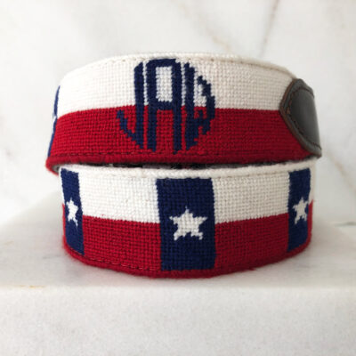 A pair of red, white and blue bracelets with the letters j p m