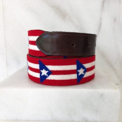 A red, white and blue belt with a brown leather strap.