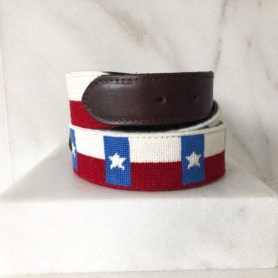 A red, white and blue belt sitting on top of a counter.
