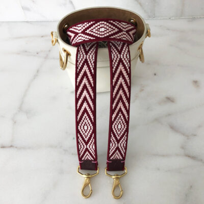 A red and white strap with gold accents.