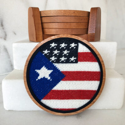 A round wooden frame with an american flag on it.