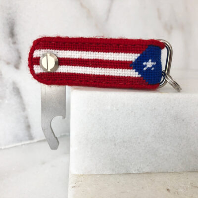 A red, white and blue key chain with a star on it.