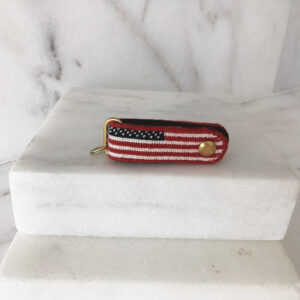 A red, white and blue flag is on the marble.