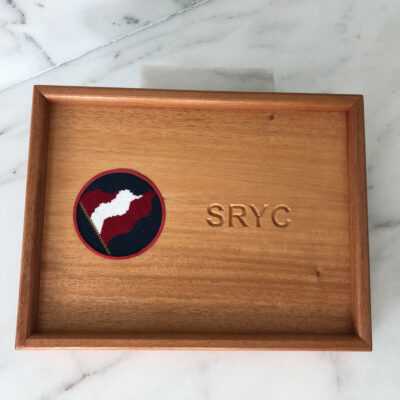 A wooden tray with the letters sryc on it