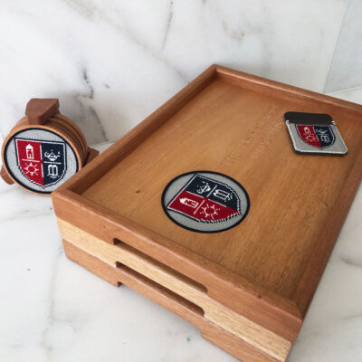 A wooden tray with two coasters and one watch.