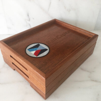 A wooden box with a round emblem on top of it.