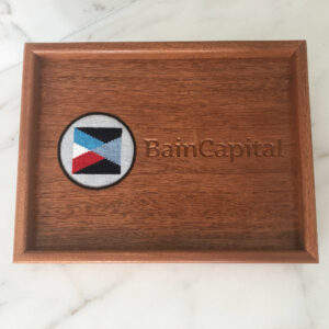 A wooden tray with the words bain capital on it.