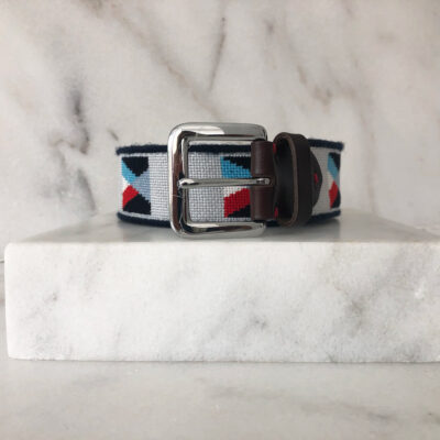 A white and blue belt sitting on top of a marble counter.
