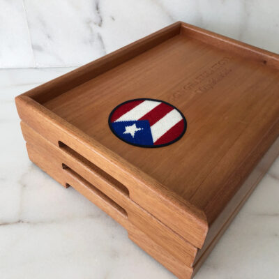 A wooden tray with a red, white and blue circle on it.