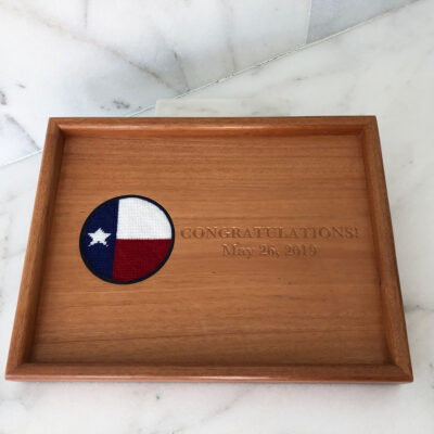 A wooden tray with texas flag on it.