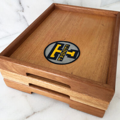 A wooden tray with a logo on it.