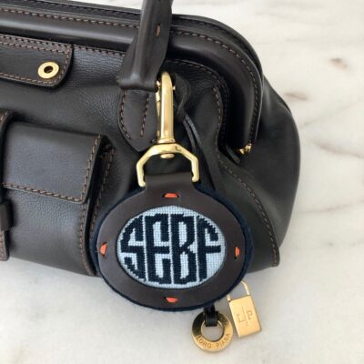A purse with a key chain that says " scbga ".