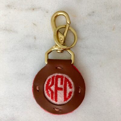 A brown key chain with a red circle on it.