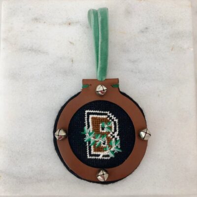 A brown and green ornament with the letter b.