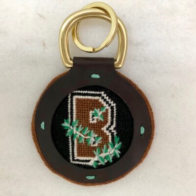 A brown key chain with the letter b on it.